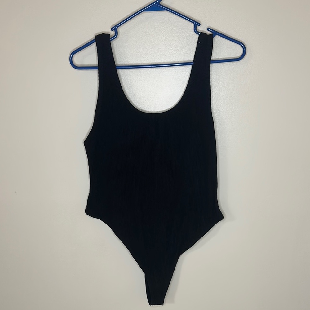 Woman’s black ribbed body suit